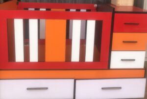 Baby cot with drawers and shelves